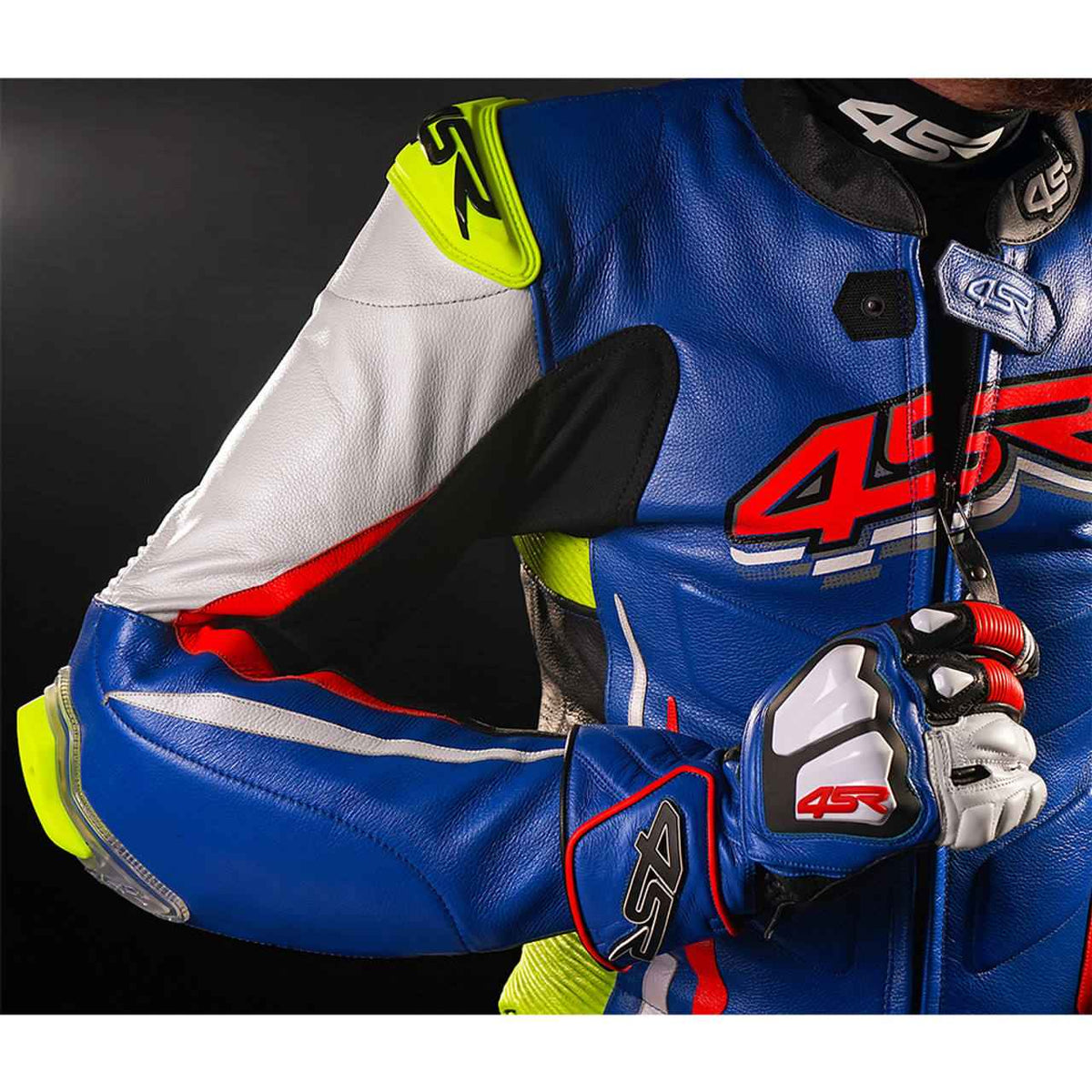 Front view of blue one-piece cowhide motorcycle racing suit with white, red and neon yellow panels and external knee sliders