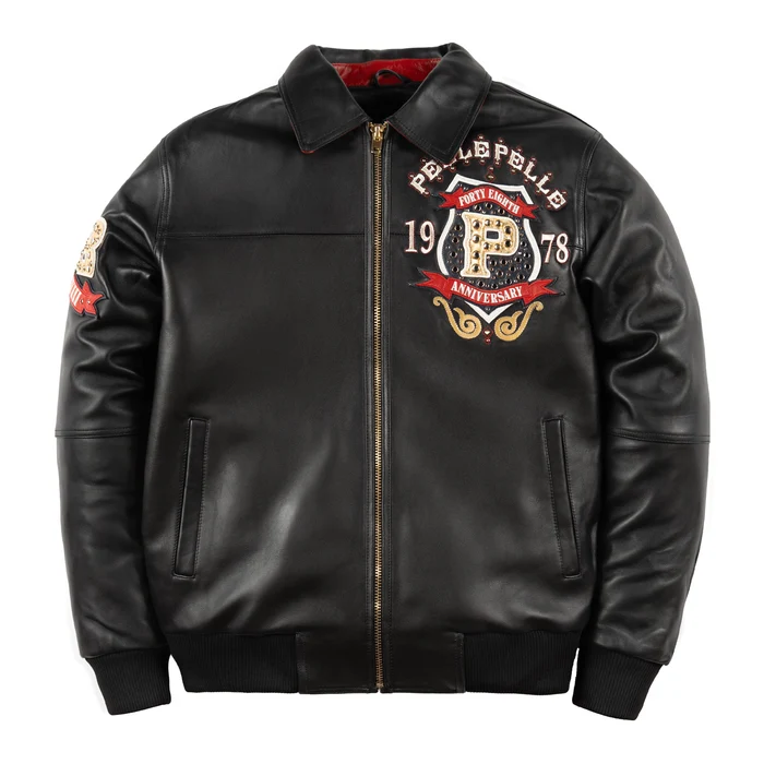 Front of black anniversary leather jacket with Pelle Pelle lettering, decorated chest crest, gold-tone zipper and ribbed cuffs.