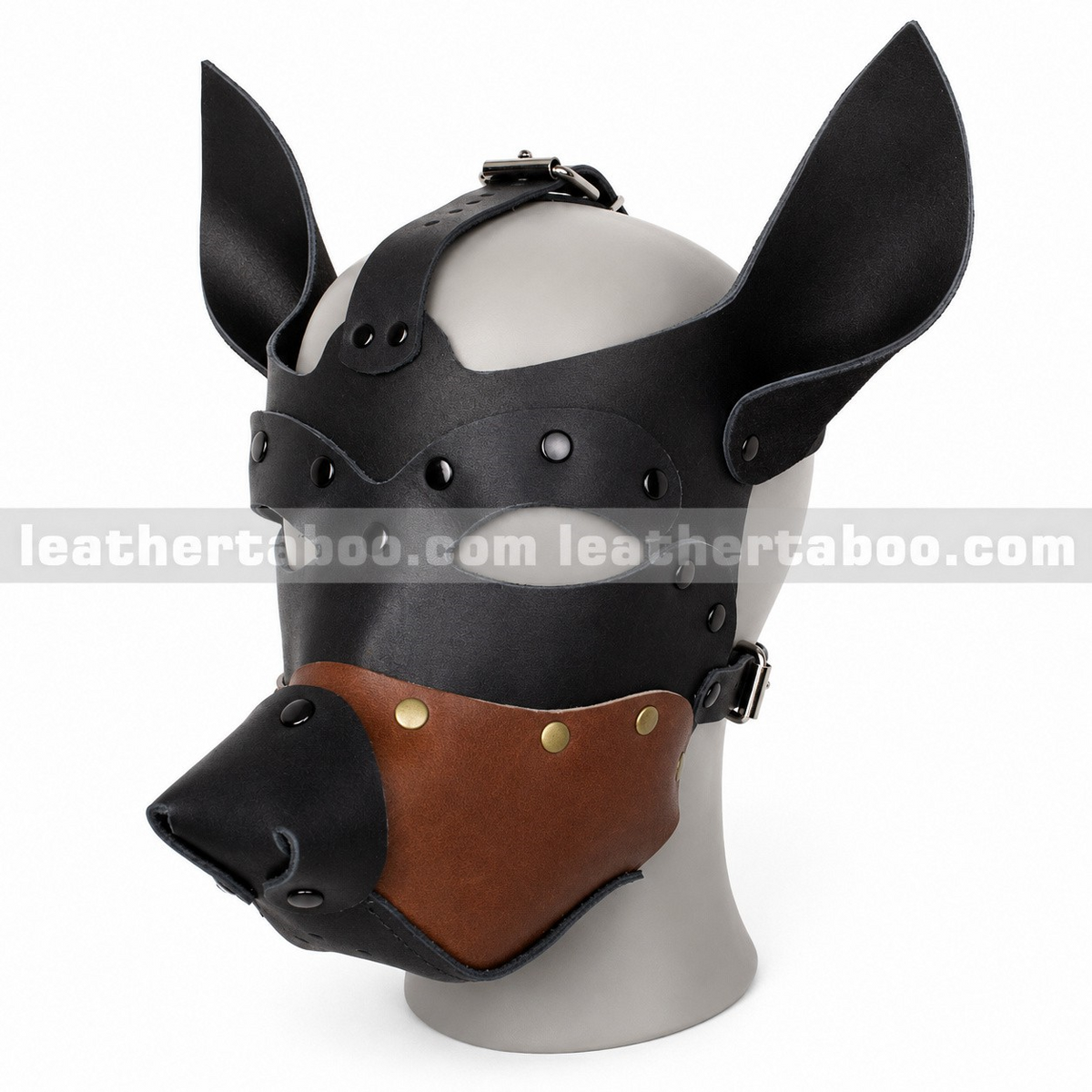 Angled view of black and brown leather dog mask with tall pointed ears, shaped muzzle, open eye cutouts and buckle straps on a white mannequin.