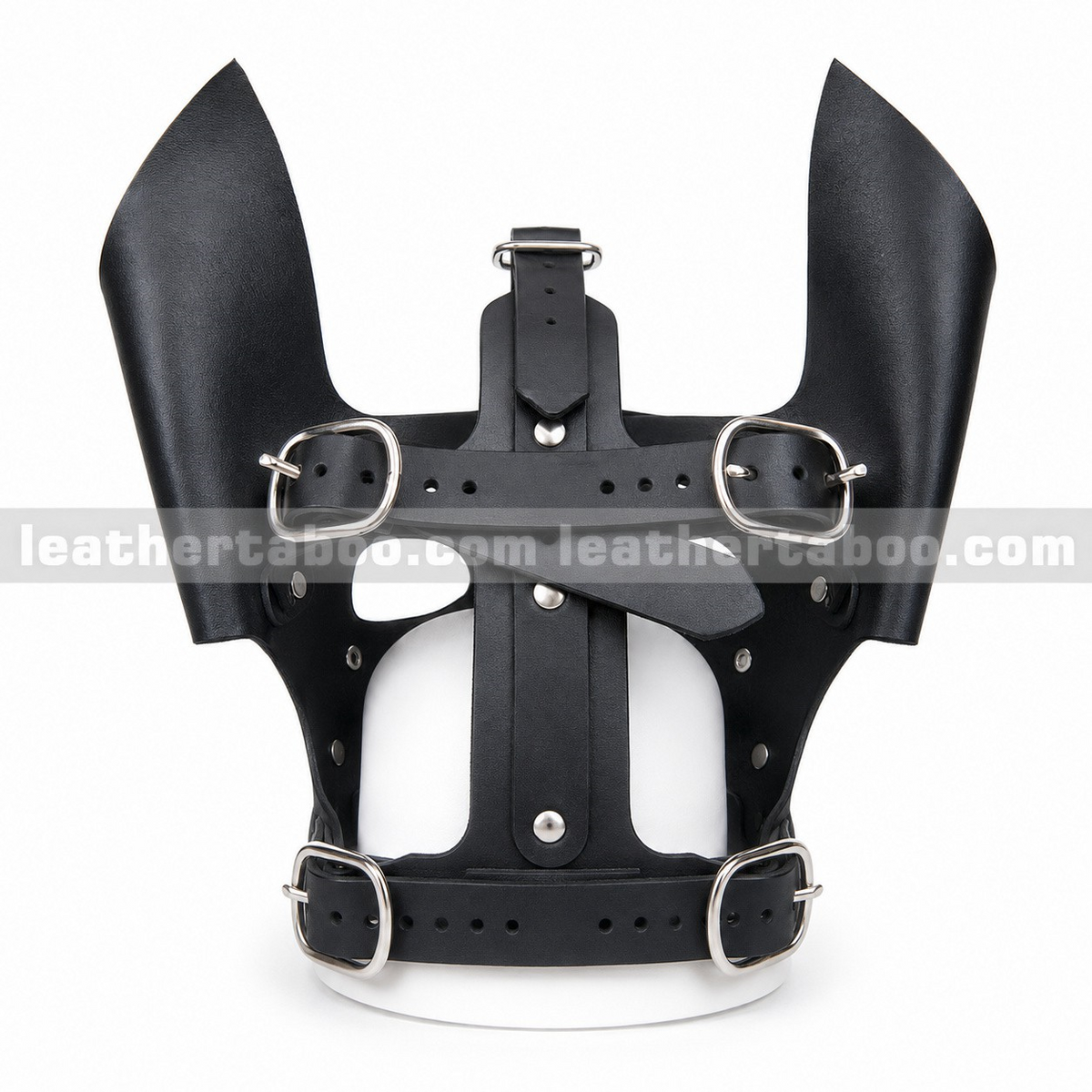Rear view of leather dog mask with tall black ears, open strap framework, adjustable buckles and central crown strap on a white mannequin.