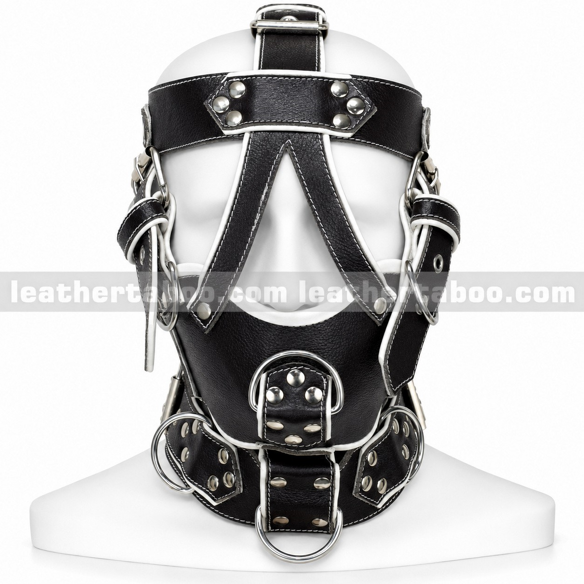 Front view of black leather head harness with white trim, open eye area, covered mouth panel and silver-tone D-rings on a white mannequin.